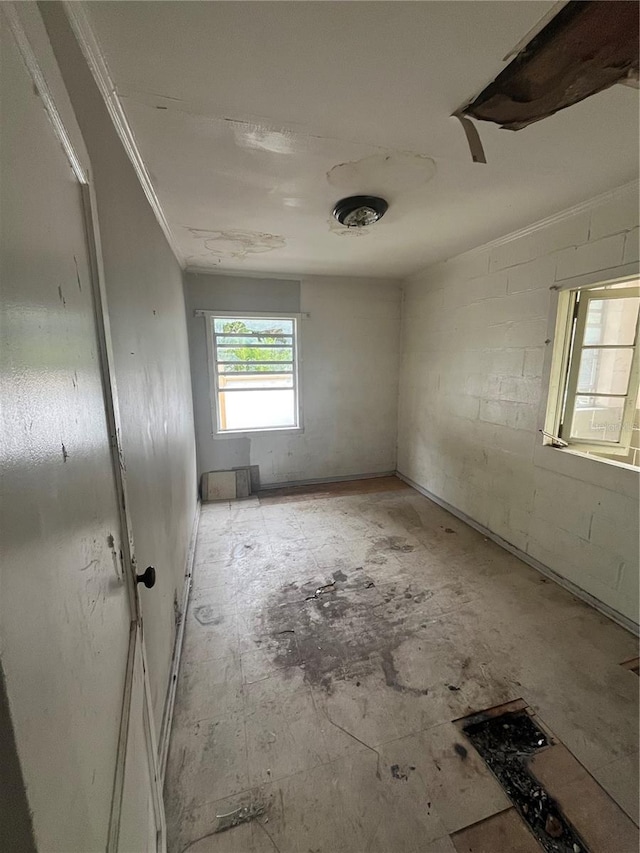 1905 S Westmoreland Dr, Orlando, FL 32805 - spare room featuring ornamental molding and concrete block wall