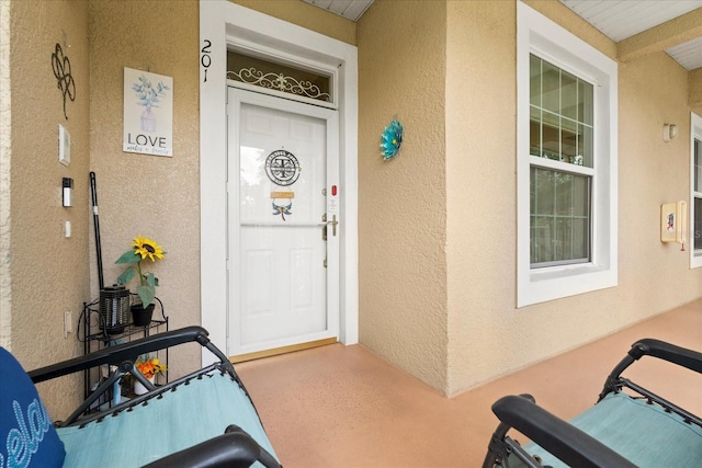2808 Osprey Cove Pl Unit 201, Kissimmee, FL 34746 - doorway to property with stucco siding and a porch