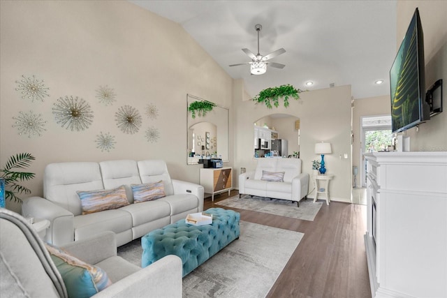 2808 Osprey Cove Pl Unit 201, Kissimmee, FL 34746 - living area featuring a ceiling fan, wood finished floors, arched walkways, vaulted ceiling, and baseboards