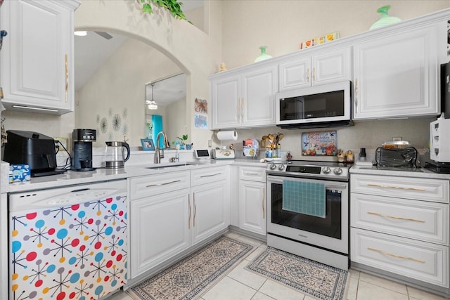2808 Osprey Cove Pl Unit 201, Kissimmee, FL 34746 - kitchen featuring white appliances, a sink, arched walkways, white cabinetry, and light countertops