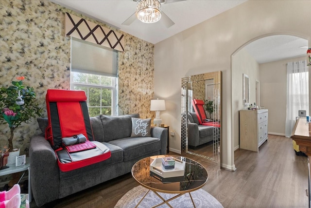 2808 Osprey Cove Pl Unit 201, Kissimmee, FL 34746 - living area with arched walkways, ceiling fan, wood finished floors, and baseboards