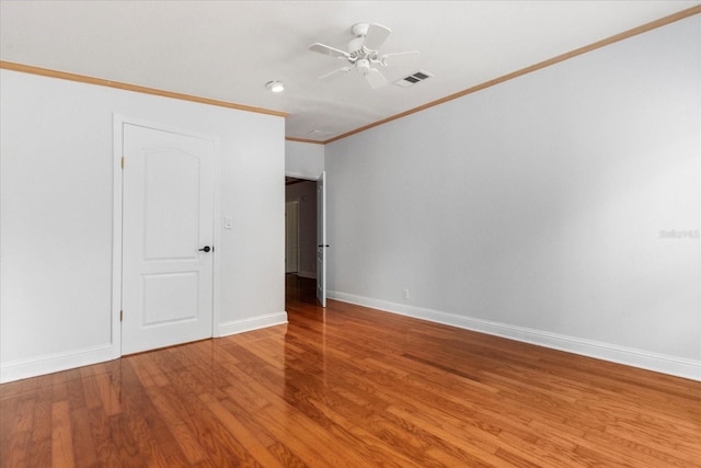 10809 Cedar Cove Dr, Thonotosassa, FL 33592 - unfurnished bedroom featuring baseboards, crown molding, a ceiling fan, visible vents, and wood finished floors