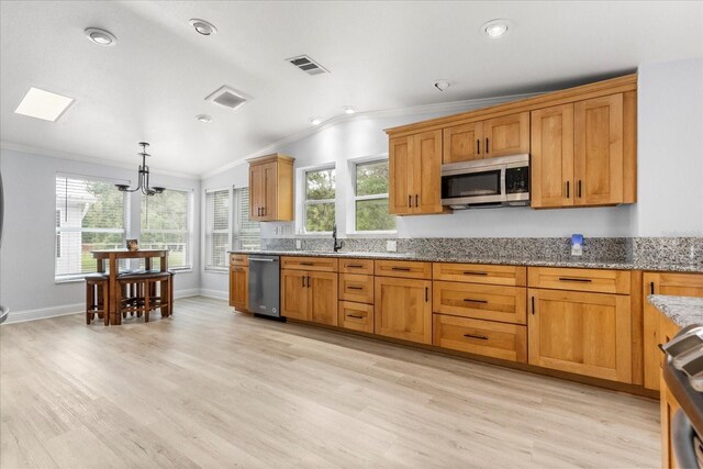 10809 Cedar Cove Dr, Thonotosassa, FL 33592 - kitchen with visible vents, a sink, appliances with stainless steel finishes, crown molding, and light wood finished floors