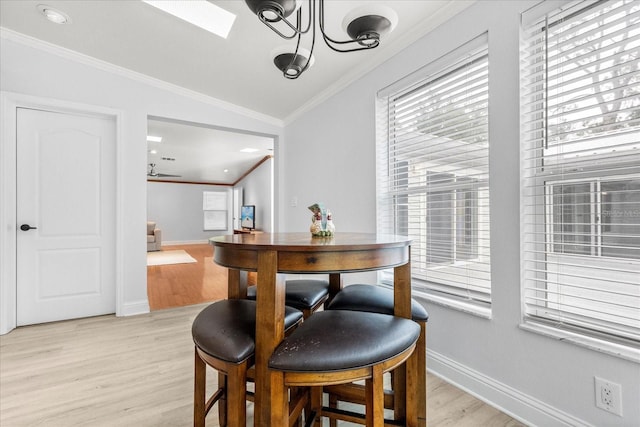 10809 Cedar Cove Dr, Thonotosassa, FL 33592 - dining room featuring ornamental molding, baseboards, light wood-style floors, and lofted ceiling