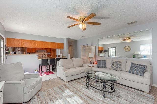 4520 Browning Ave, Titusville, FL 32780 - living area featuring visible vents, a ceiling fan, light carpet, and a textured ceiling