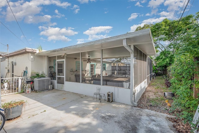 4520 Browning Ave, Titusville, FL 32780 - rear view of house featuring a sunroom, a patio, and central AC