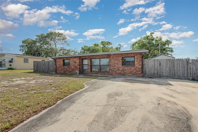 4520 Browning Ave, Titusville, FL 32780 - ranch-style house featuring brick siding, a front yard, and fence