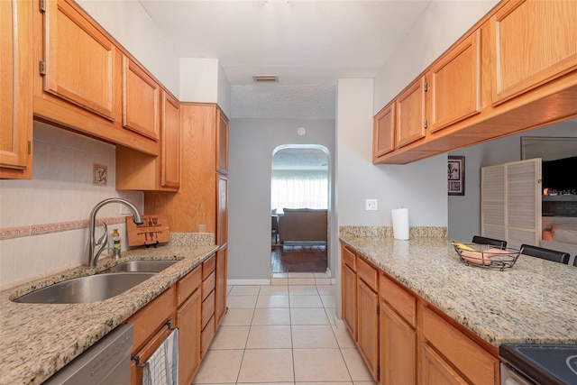 4520 Browning Ave, Titusville, FL 32780 - kitchen featuring light tile patterned flooring, light stone countertops, visible vents, stainless steel appliances, and a sink