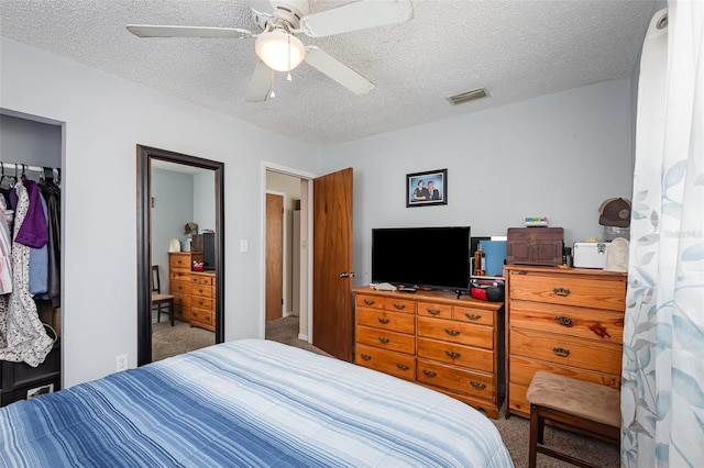 4520 Browning Ave, Titusville, FL 32780 - carpeted bedroom with visible vents, ceiling fan, a closet, and a textured ceiling
