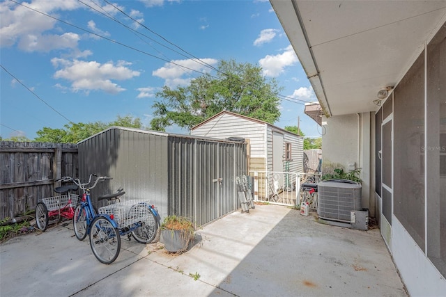 4520 Browning Ave, Titusville, FL 32780 - view of patio featuring cooling unit, an outbuilding, and a fenced backyard