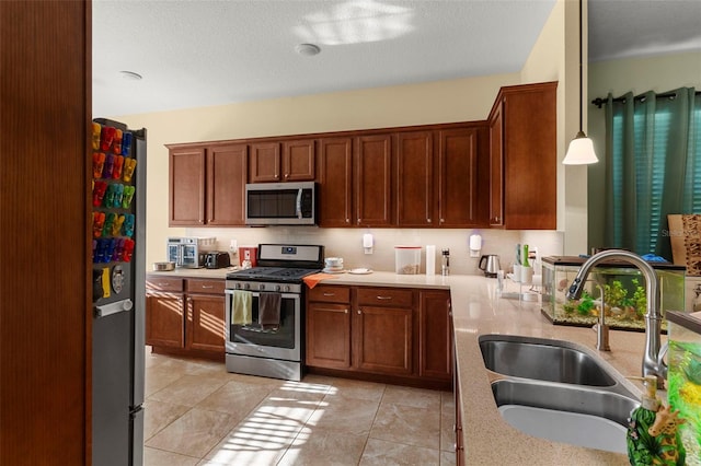 kitchen with a sink, stainless steel appliances, light tile patterned floors, and brown cabinets