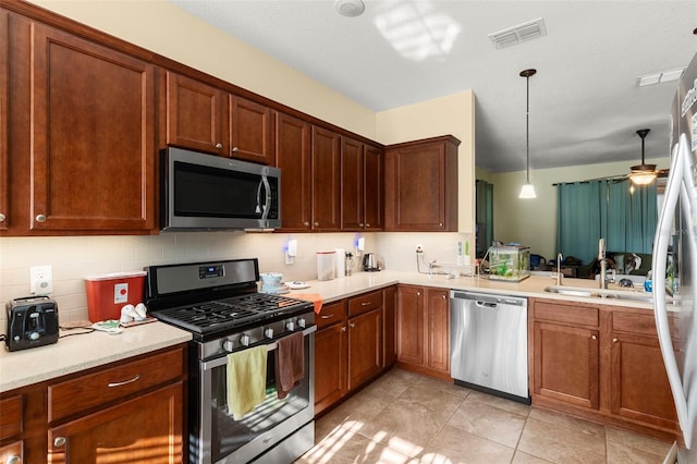 kitchen with visible vents, ceiling fan, stainless steel appliances, tasteful backsplash, and pendant lighting