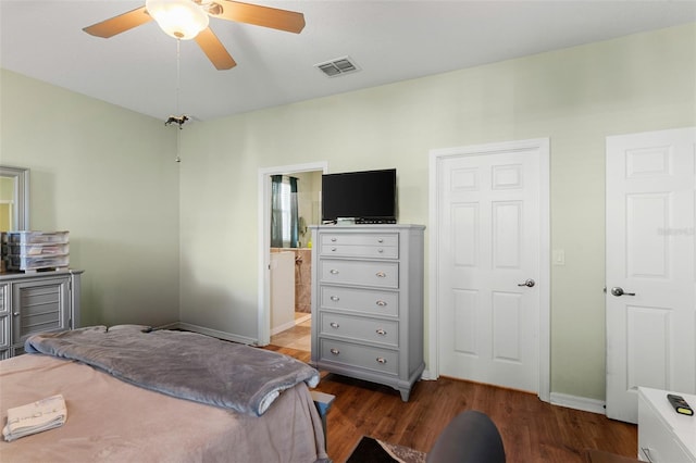 bedroom with baseboards, visible vents, a ceiling fan, ensuite bathroom, and wood finished floors