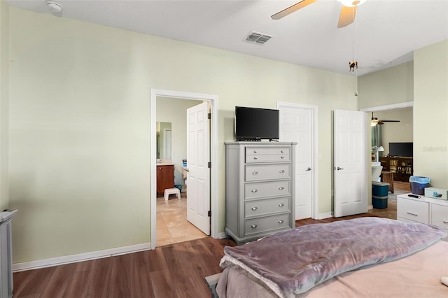 bedroom with wood finished floors, baseboards, ceiling fan, and visible vents