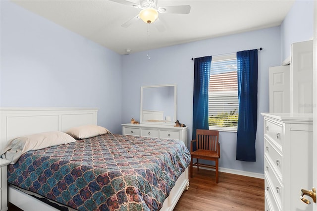 bedroom with baseboards, ceiling fan, and light wood-style floors