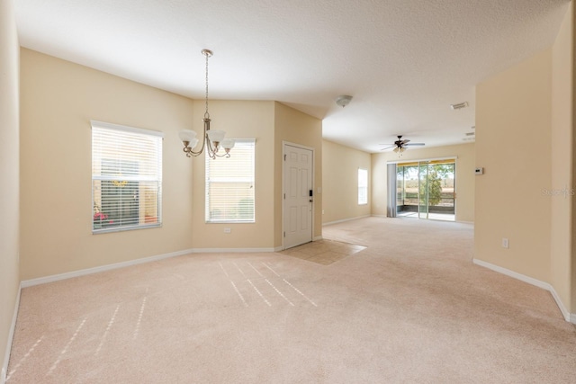 3205 Sonesta Ct Unit F, Clermont, FL 34711 - unfurnished room featuring ceiling fan with notable chandelier, a textured ceiling, baseboards, light colored carpet, and visible vents