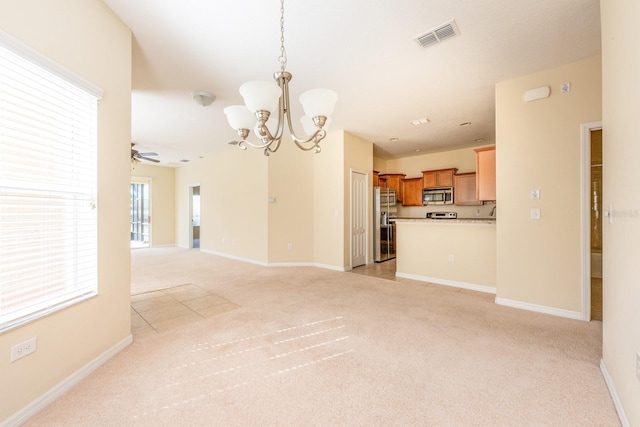 3205 Sonesta Ct Unit F, Clermont, FL 34711 - interior space with light carpet, baseboards, visible vents, and ceiling fan with notable chandelier