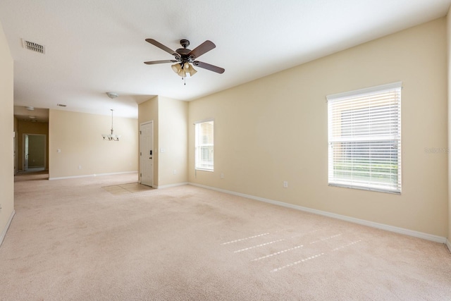 3205 Sonesta Ct Unit F, Clermont, FL 34711 - unfurnished room featuring light carpet, a wealth of natural light, visible vents, and ceiling fan with notable chandelier