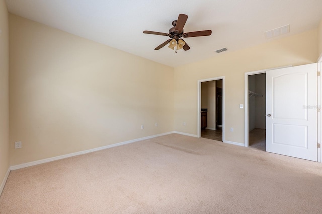 3205 Sonesta Ct Unit F, Clermont, FL 34711 - unfurnished bedroom with baseboards, carpet flooring, visible vents, and a walk in closet