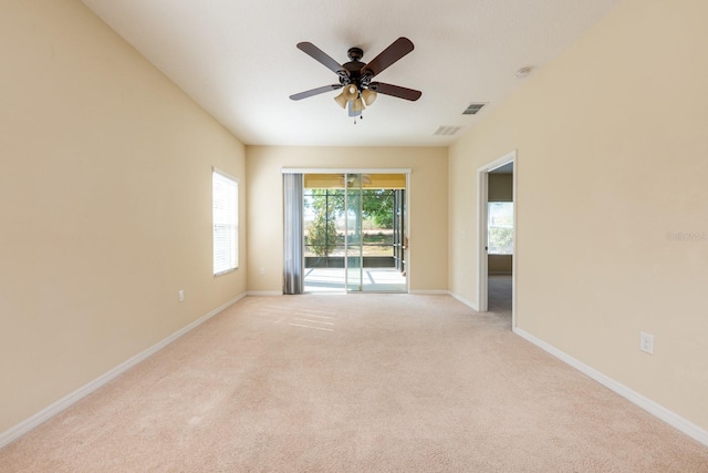 3205 Sonesta Ct Unit F, Clermont, FL 34711 - spare room with baseboards, visible vents, a ceiling fan, and light carpet