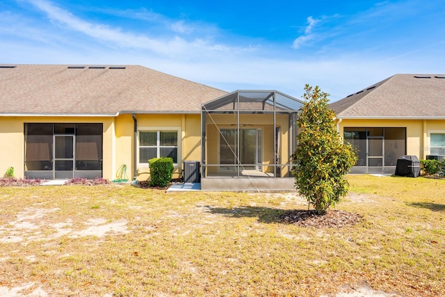 3205 Sonesta Ct Unit F, Clermont, FL 34711 - rear view of house featuring stucco siding, a lawn, and a lanai