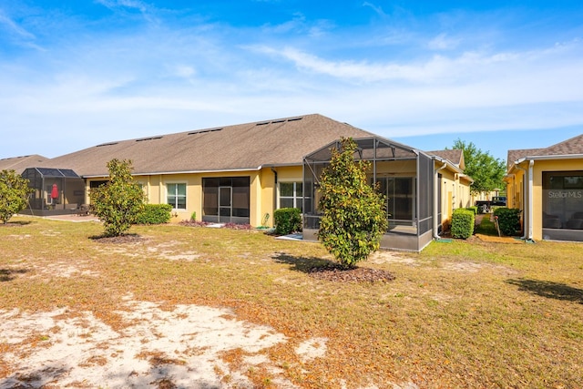 3205 Sonesta Ct Unit F, Clermont, FL 34711 - rear view of house with stucco siding, a lanai, roof with shingles, and a lawn