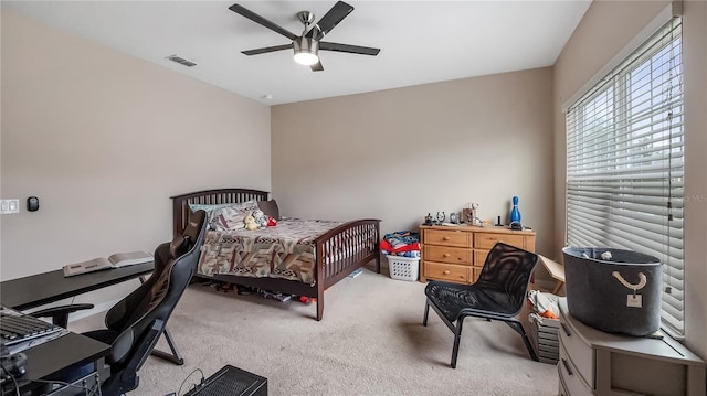 carpeted bedroom with visible vents and a ceiling fan