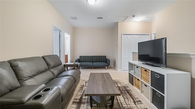living area with light colored carpet, baseboards, and visible vents