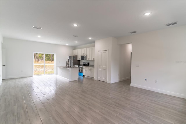 unfurnished living room featuring recessed lighting, visible vents, and light wood-style flooring