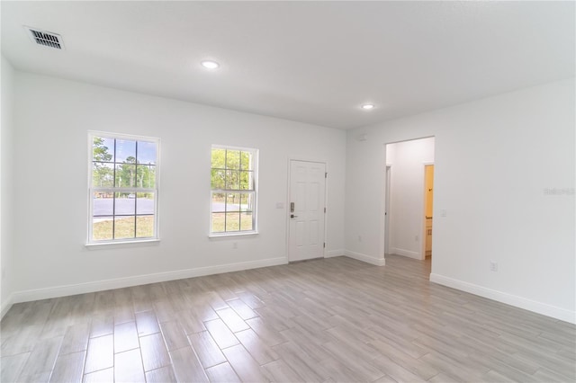 spare room featuring visible vents, baseboards, light wood finished floors, and recessed lighting