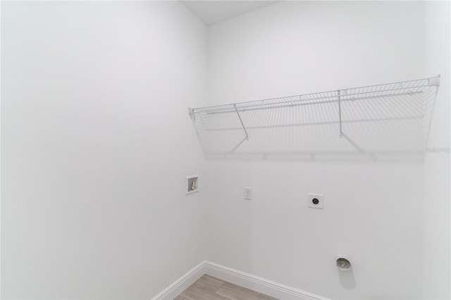 washroom featuring hookup for an electric dryer, light wood-type flooring, baseboards, laundry area, and hookup for a washing machine