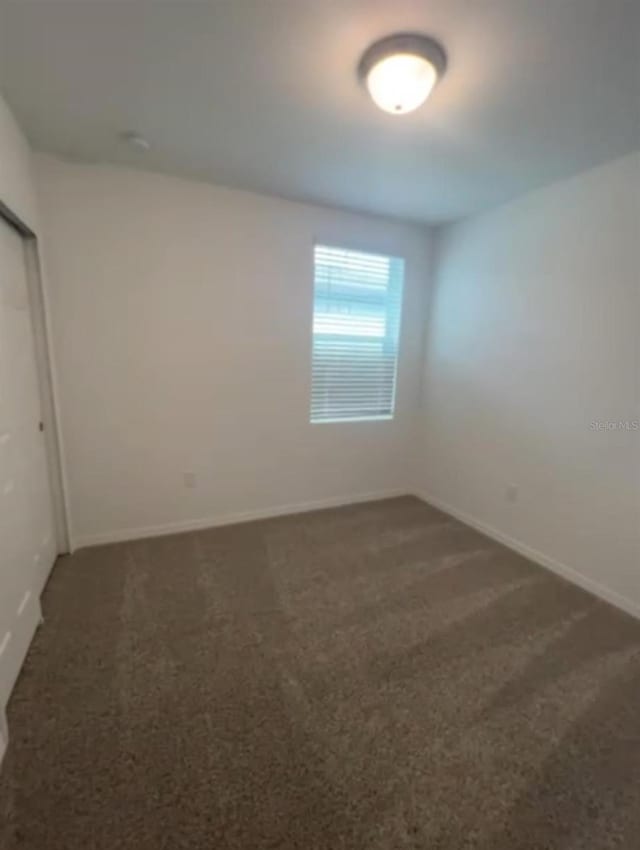 6028 Bimini Ave, Haines City, FL 33844 - unfurnished bedroom with carpet, baseboards, and a closet