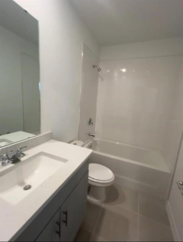 6028 Bimini Ave, Haines City, FL 33844 - bathroom with toilet, vanity,  shower combination, and tile patterned floors