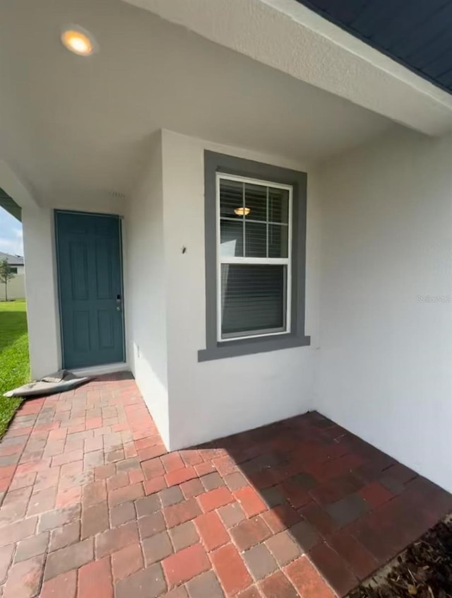 6028 Bimini Ave, Haines City, FL 33844 - doorway to property featuring stucco siding
