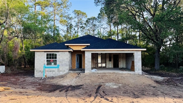 property in mid-construction with stone siding and roof with shingles