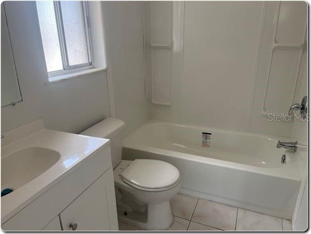 full bath with vanity, tile patterned flooring, washtub / shower combination, and toilet