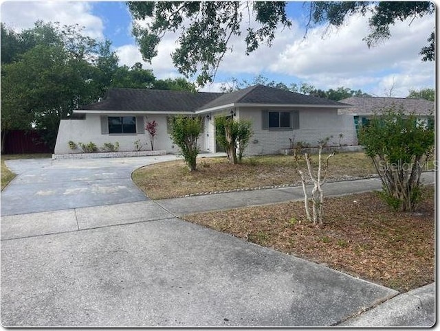 4736 Southold St, Orlando, FL 32808 - ranch-style house featuring brick siding and driveway