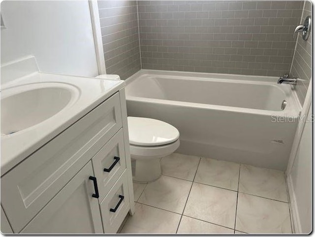 4736 Southold St, Orlando, FL 32808 - full bathroom featuring toilet, tile patterned flooring, vanity, and shower / tub combination