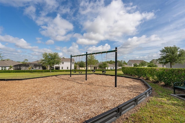 view of home's community with a lawn, a residential view, and playground community