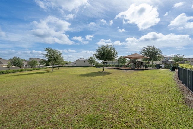 view of yard featuring a residential view, fence, and a gazebo