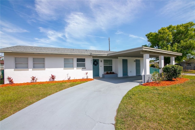 1831 Aaron Ave, Orlando, FL 32811 - ranch-style home with stucco siding, concrete driveway, a front yard, and a carport