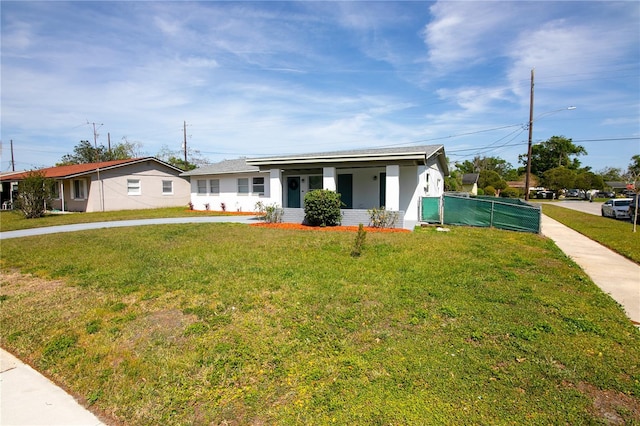 1831 Aaron Ave, Orlando, FL 32811 - view of front of property featuring stucco siding, fence, and a front lawn