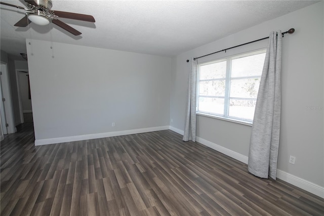 1831 Aaron Ave, Orlando, FL 32811 - empty room with baseboards, dark wood-style flooring, a textured ceiling, and ceiling fan
