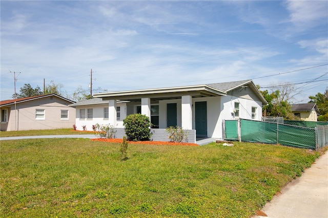 1831 Aaron Ave, Orlando, FL 32811 - view of front facade featuring stucco siding, fence, and a front lawn