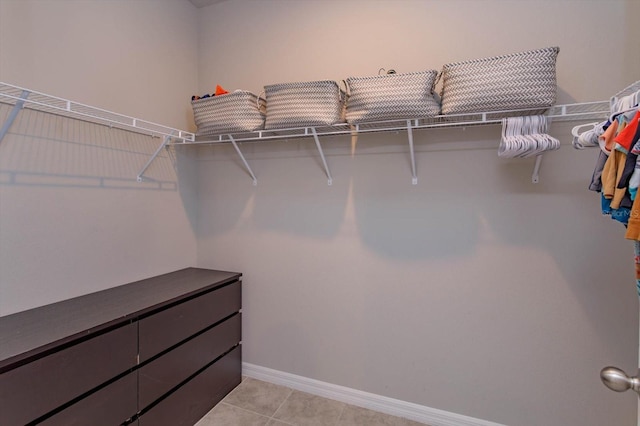 walk in closet featuring light tile patterned flooring