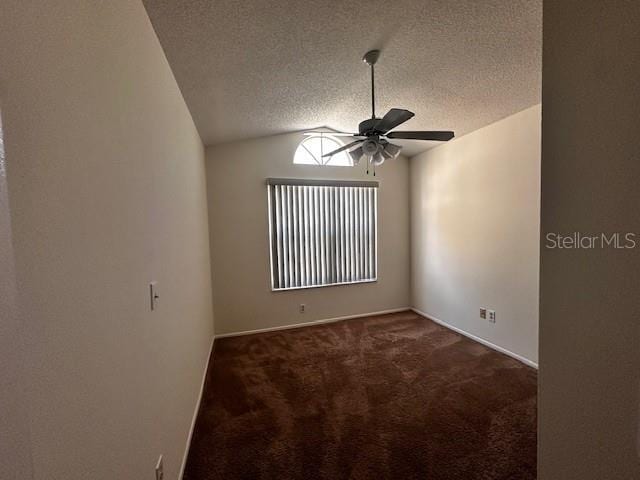 spare room with carpet flooring, a textured ceiling, vaulted ceiling, and ceiling fan