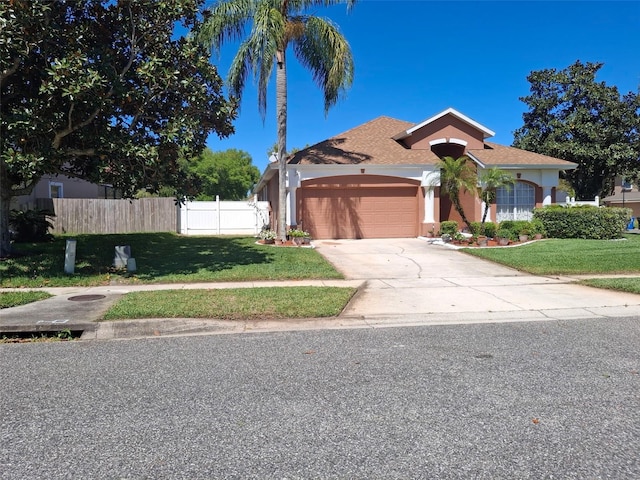450 Morning Blossom Ln, Oviedo, FL 32765 - mediterranean / spanish-style house featuring stucco siding, an attached garage, fence, and a front yard
