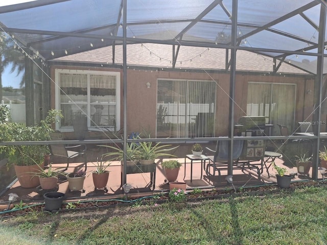 450 Morning Blossom Ln, Oviedo, FL 32765 - rear view of property with a shingled roof, glass enclosure, and stucco siding