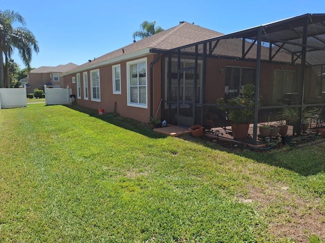 450 Morning Blossom Ln, Oviedo, FL 32765 - back of property featuring a yard, roof with shingles, a lanai, and stucco siding