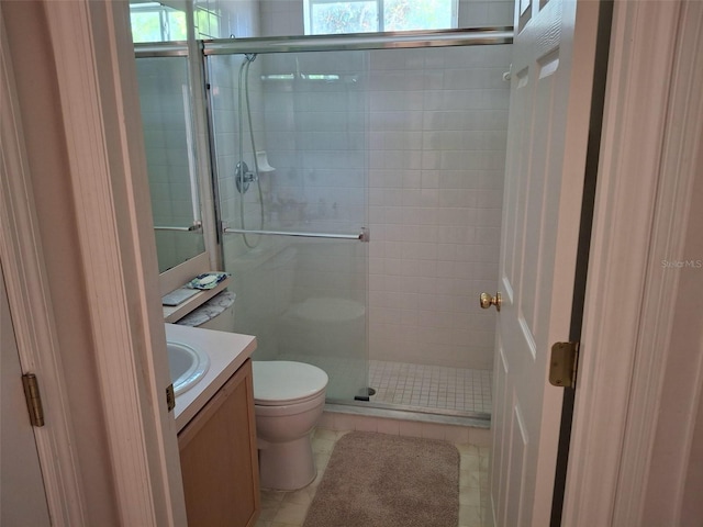 450 Morning Blossom Ln, Oviedo, FL 32765 - full bathroom featuring a shower stall, toilet, vanity, and tile patterned floors